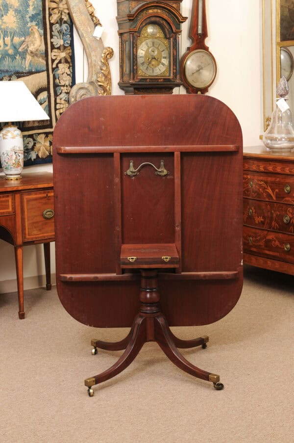 English 19th Century Plum Pudding Mahogany Rectangular Breakfast Table with Ebonized Inlay and Pedestal Base and 4 Splayed Legs on Brass Castor Feet - Image 3