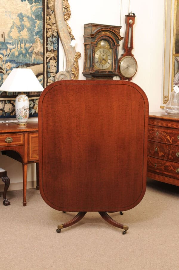 English 19th Century Plum Pudding Mahogany Rectangular Breakfast Table with Ebonized Inlay and Pedestal Base and 4 Splayed Legs on Brass Castor Feet - Image 5