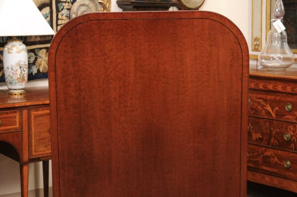 English 19th Century Plum Pudding Mahogany Rectangular Breakfast Table with Ebonized Inlay and Pedestal Base and 4 Splayed Legs on Brass Castor Feet - Image 7