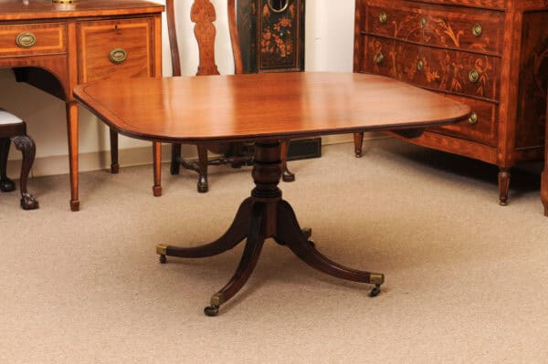 English 19th Century Plum Pudding Mahogany Rectangular Breakfast Table with Ebonized Inlay and Pedestal Base and 4 Splayed Legs on Brass Castor Feet - Image 8