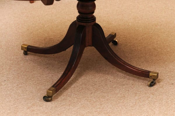 English 19th Century Plum Pudding Mahogany Rectangular Breakfast Table with Ebonized Inlay and Pedestal Base and 4 Splayed Legs on Brass Castor Feet - Image 9