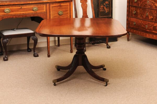 English 19th Century Plum Pudding Mahogany Rectangular Breakfast Table with Ebonized Inlay and Pedestal Base and 4 Splayed Legs on Brass Castor Feet - Image 11