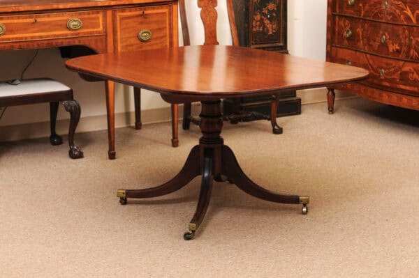 English 19th Century Plum Pudding Mahogany Rectangular Breakfast Table with Ebonized Inlay and Pedestal Base and 4 Splayed Legs on Brass Castor Feet - Image 12