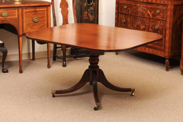 English 19th Century Plum Pudding Mahogany Rectangular Breakfast Table with Ebonized Inlay and Pedestal Base and 4 Splayed Legs on Brass Castor Feet - Image 16