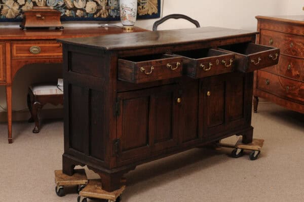 English 18th Century Oak Dresser Base Featuring 3 Drawers and 2 Flanking Cabints Below with Raised Paneled Doors and Brass Knobs - Image 4