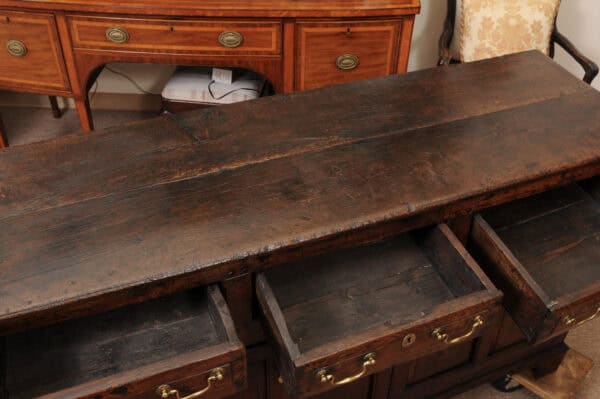 English 18th Century Oak Dresser Base Featuring 3 Drawers and 2 Flanking Cabints Below with Raised Paneled Doors and Brass Knobs - Image 6